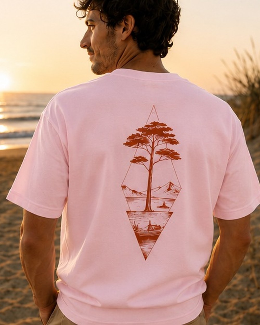 T-shirt Écume & Soleil motif Île & Pins, coloris rose, porté de dos face à l'océan